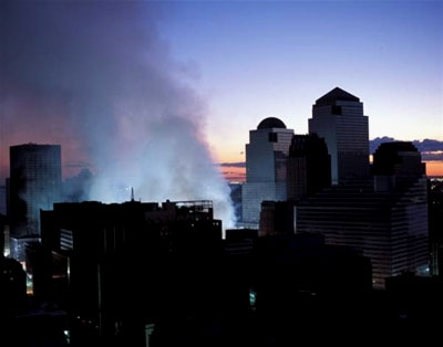 Smoke rises from Ground Zero at nightfall