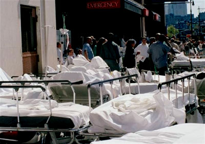 Hospital beds are lined up on the sidewalk to accomodate the injured